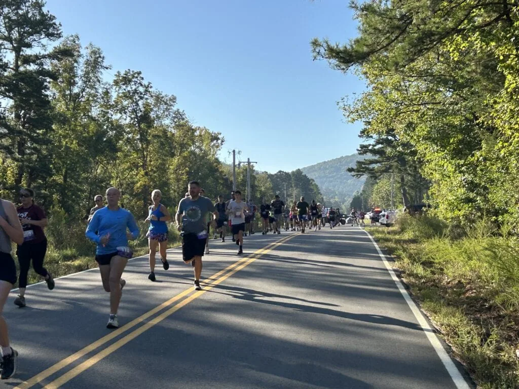 Runners run down the road.