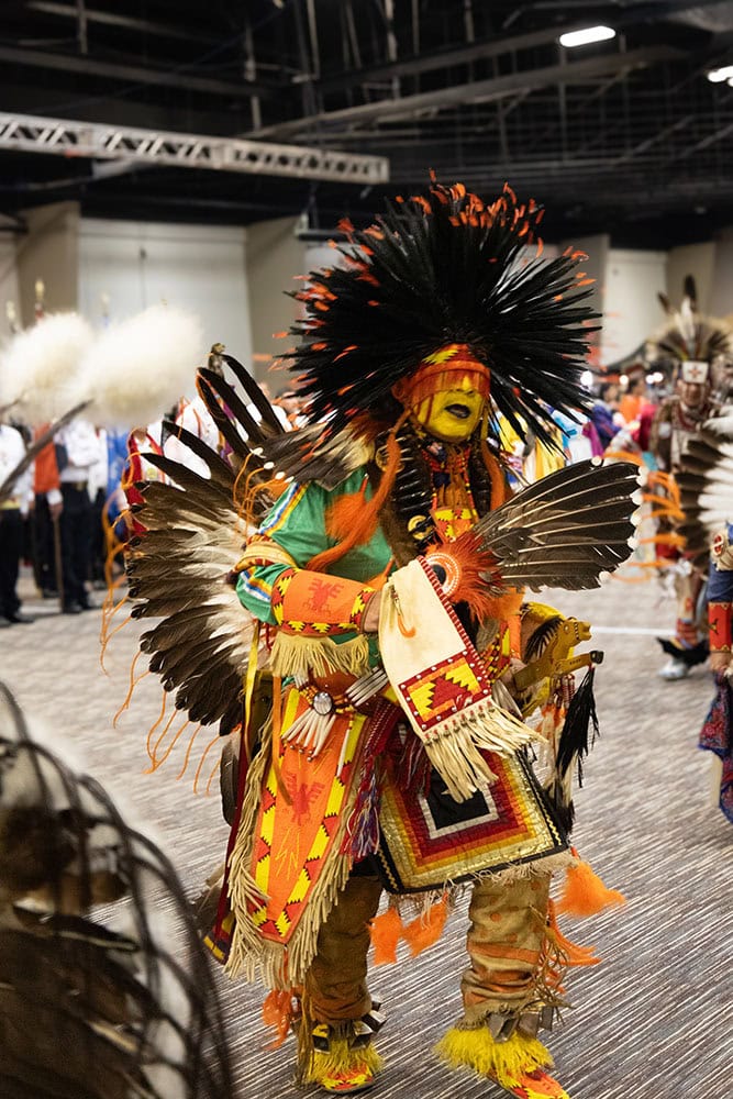 A man wears Native American regalia