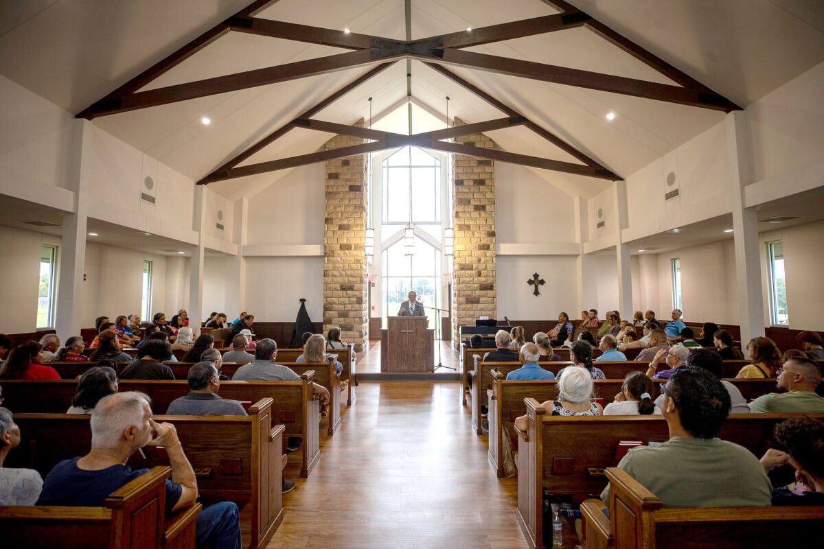 A man preaches from the pulpit.