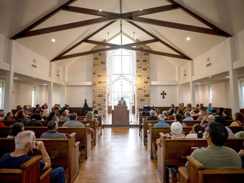 A man preaches from the pulpit.