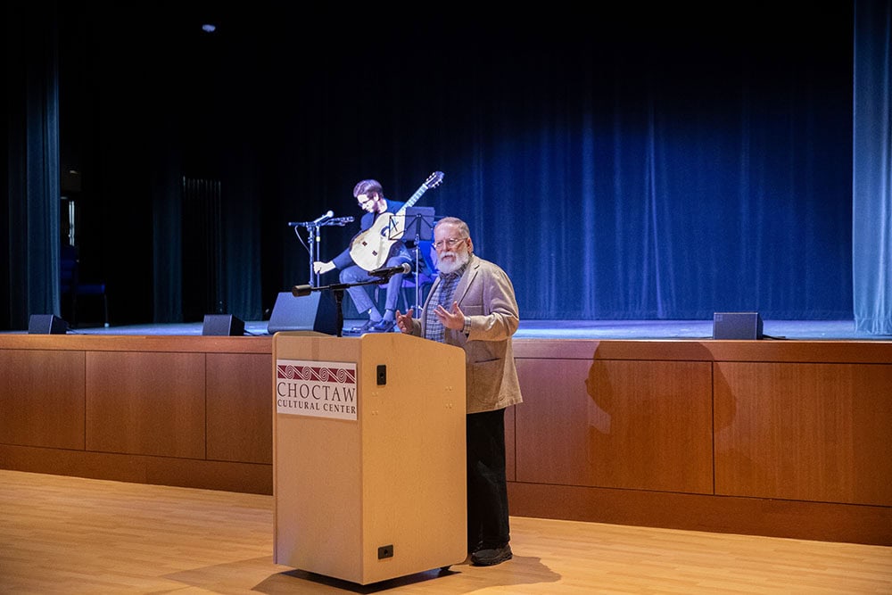 A man speaks from behind a podium.