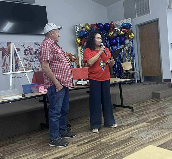 A women introduces a man standing next to her.