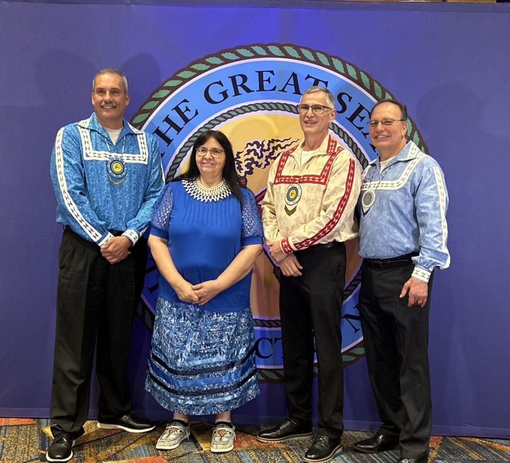 Four people pose for a photo.