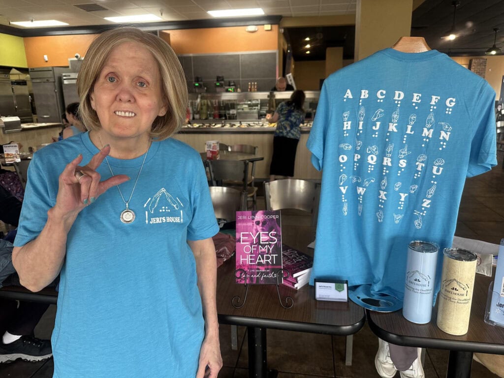 A woman uses sign language to communicate.