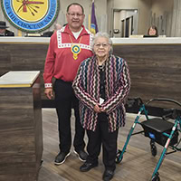 A woman poses with a man.