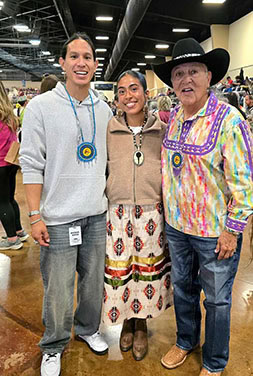 Three people pose for a photo.