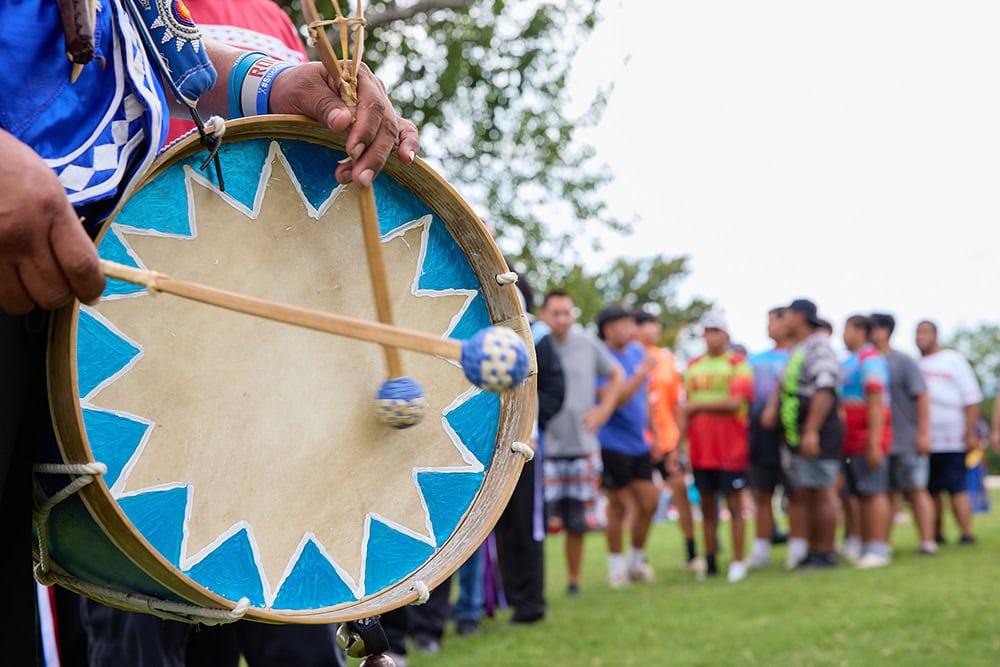 A native drum with a starburst image painted on the head.
