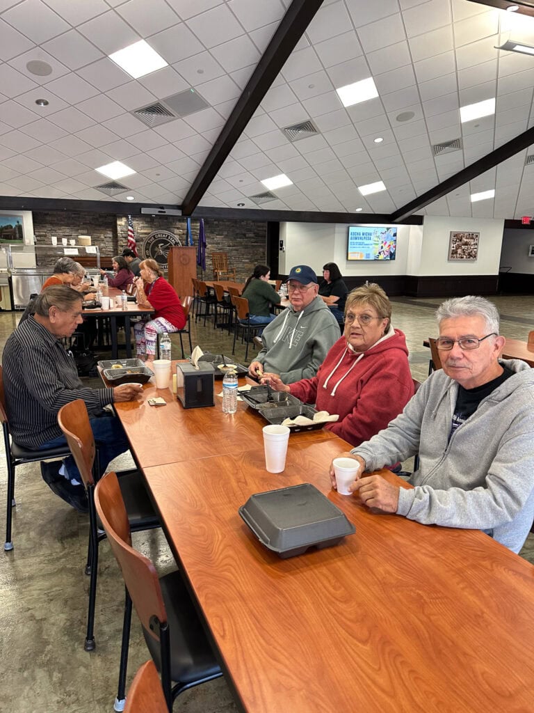 Elders wait for their meals.