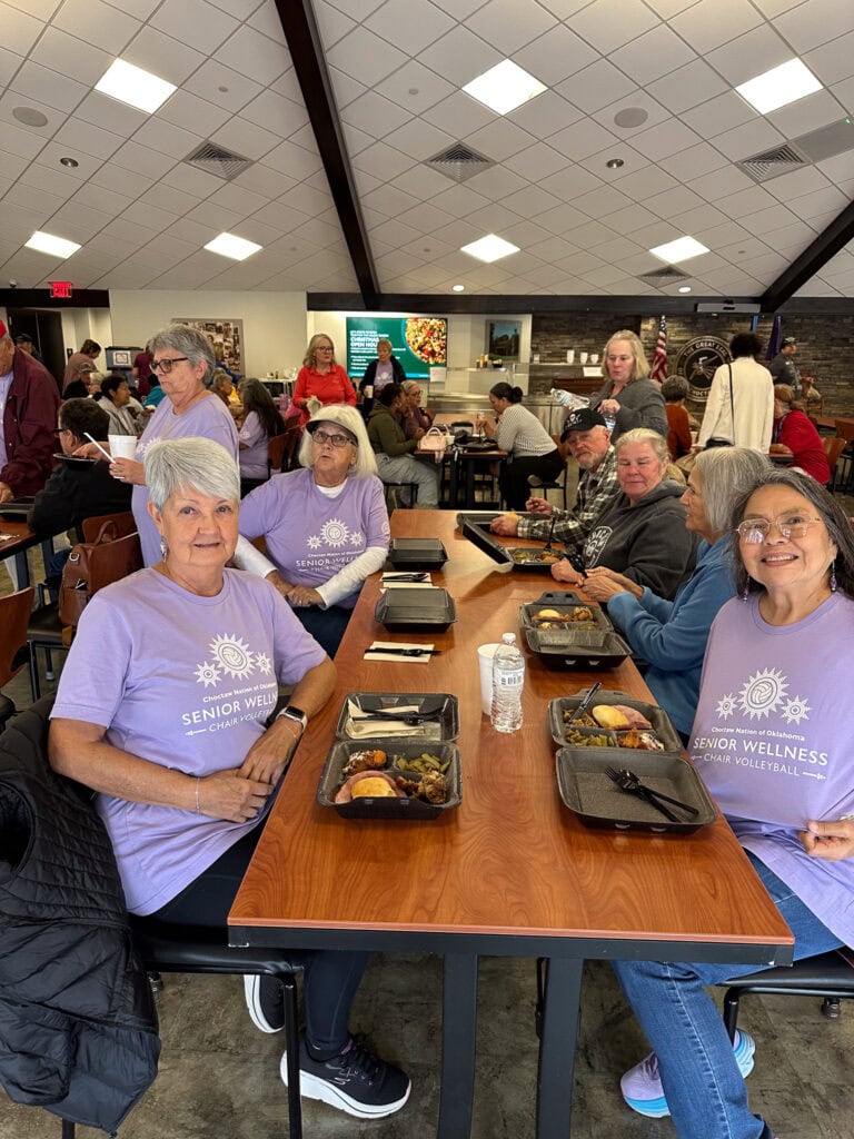Elders from a volleyball team pose for a photo.