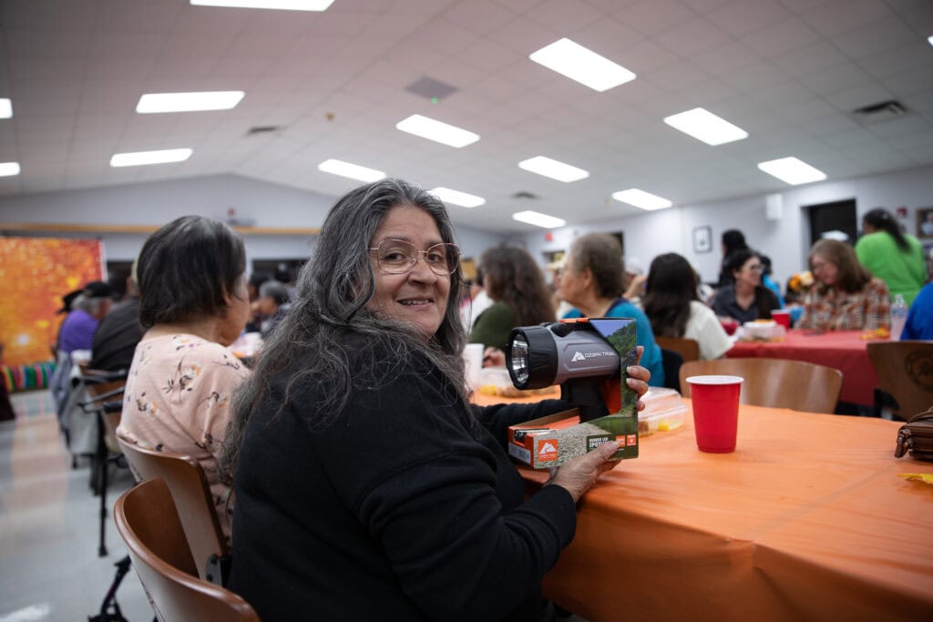 Woman shows off her door prize.