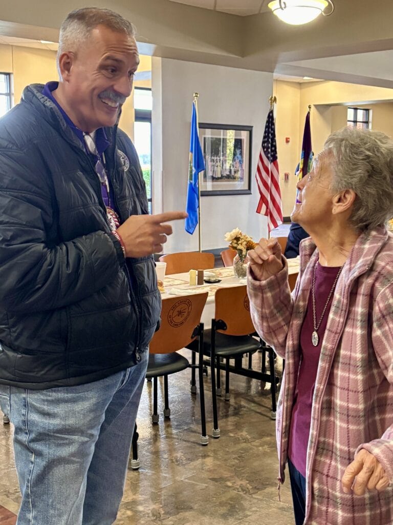 Assistant Chief and an elder share a laugh.