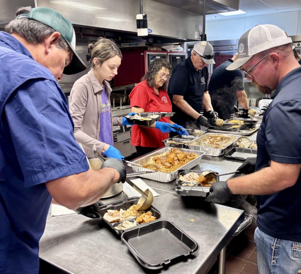 Volunteers prepare meals.