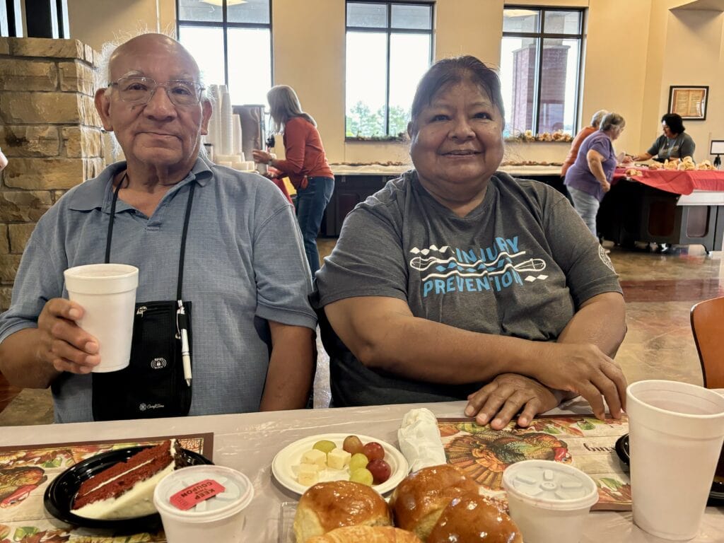 Two elders pose for a photo.