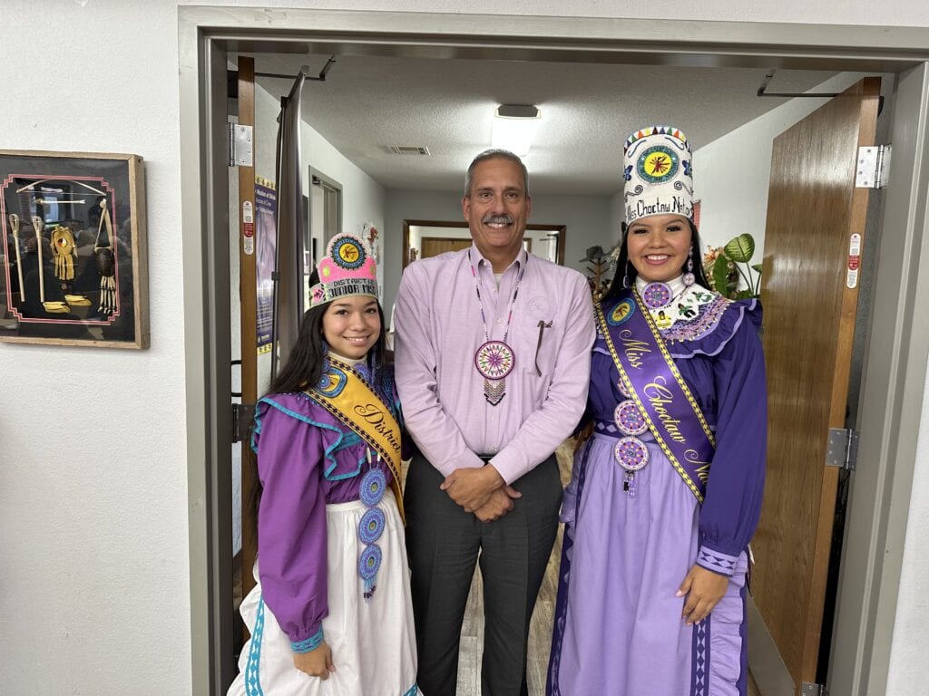 Assistant Chief takes a photo with Choctaw princesses.