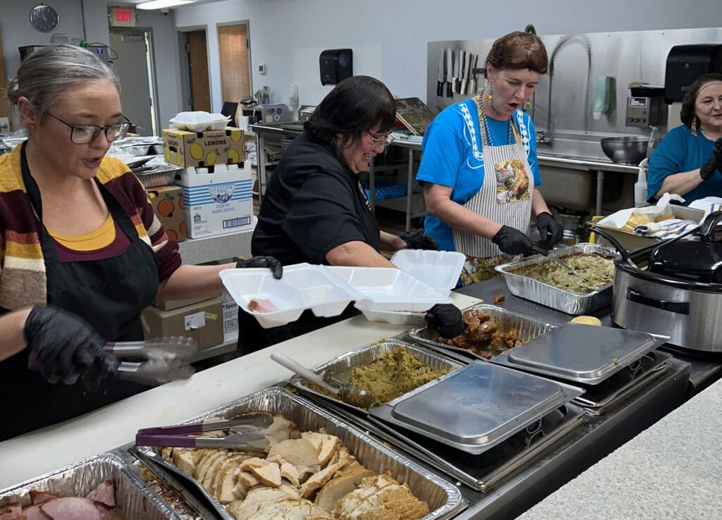Volunteers dish up meals.