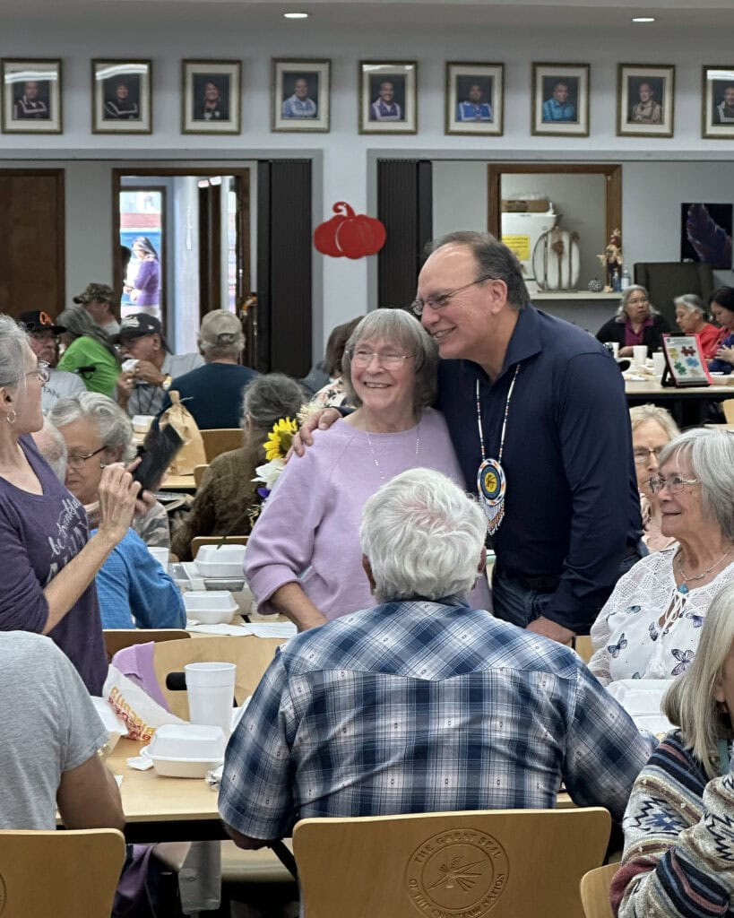 Chief Batton poses for a photo with an elder.