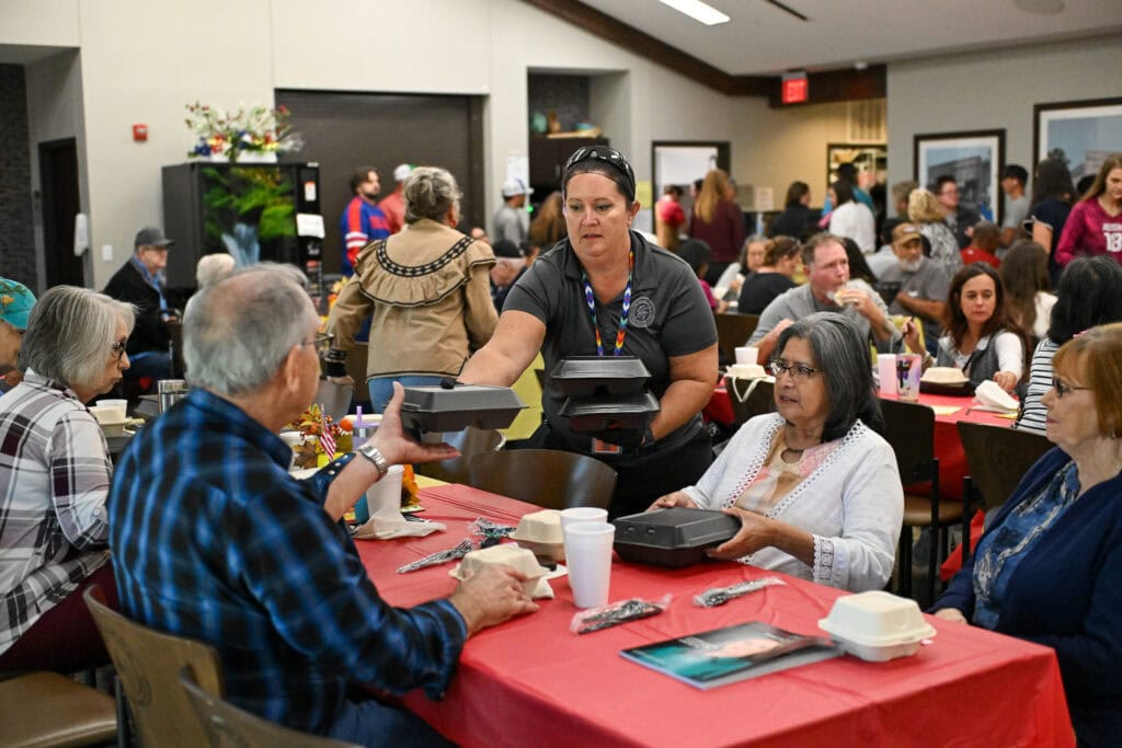 a volunteer hands out meals in atoka.