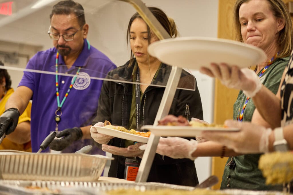 Volunteers dish up food at Crowder meal.