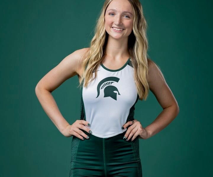 Addison Martin poses in Michigan State row team uniform.