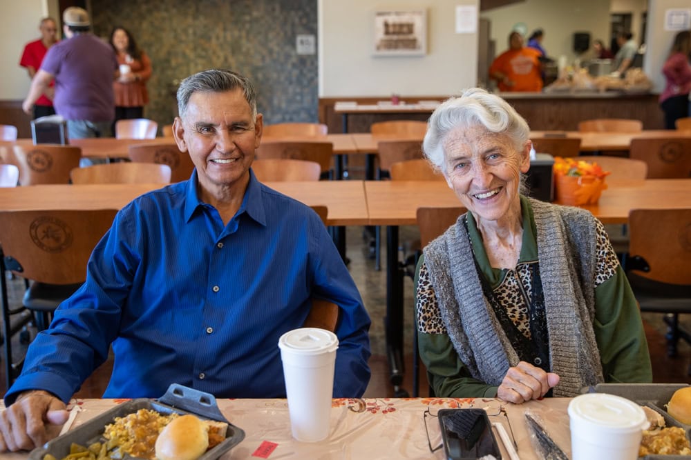Two elders pose for a photo.