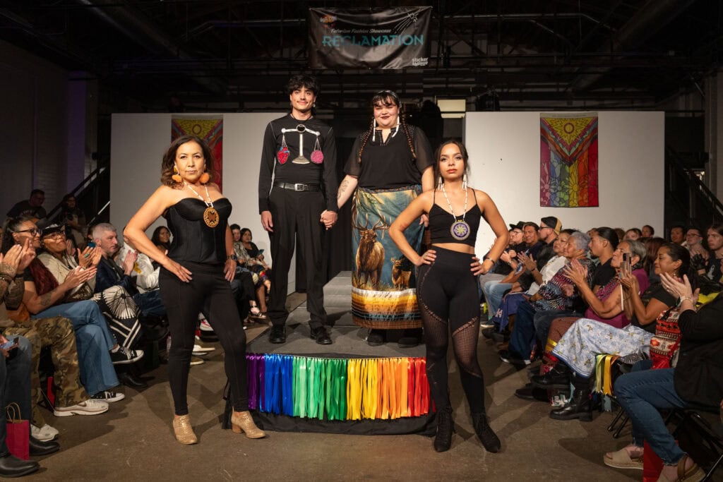 Native models pose for a photo on the runway.
