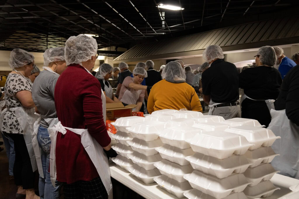 Volunteers prepare meals.