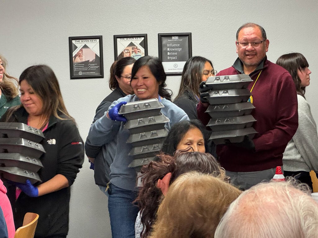 Tony Ward and other volunteers pass out meals.