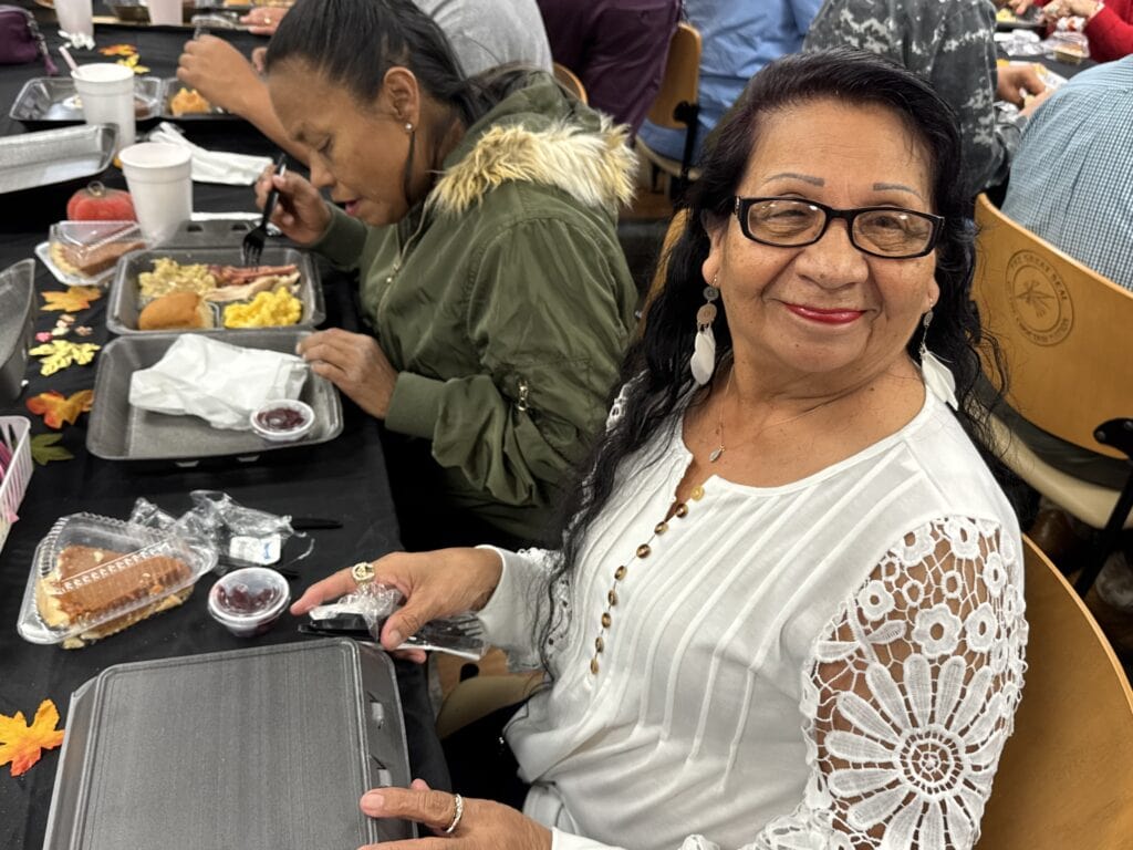 A woman smiles for a photo.