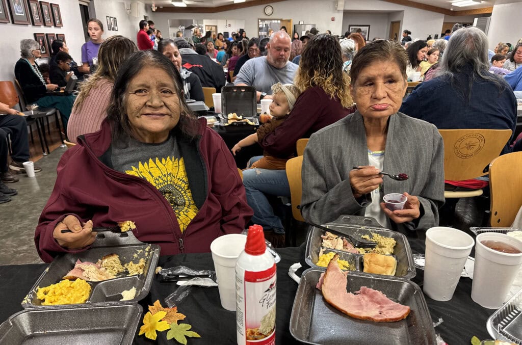 Two elders smile for a photo.