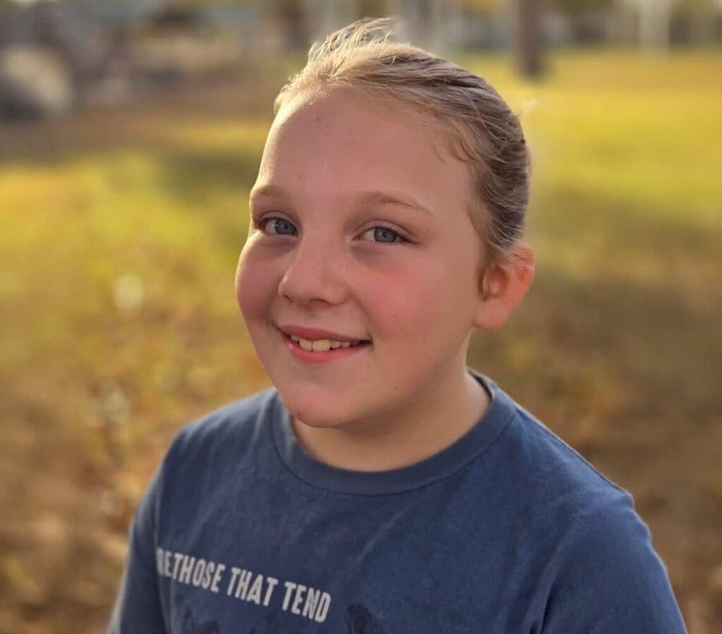 Young girl smiles for a photo.
