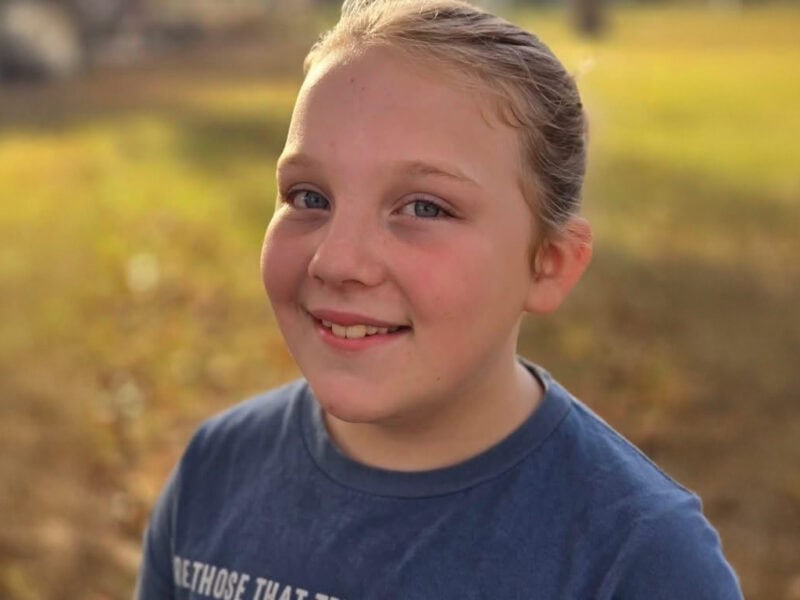 Young girl smiles for a photo.