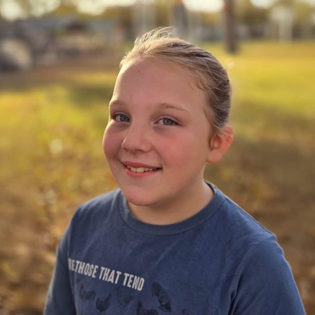 Young girl smiles for a photo.