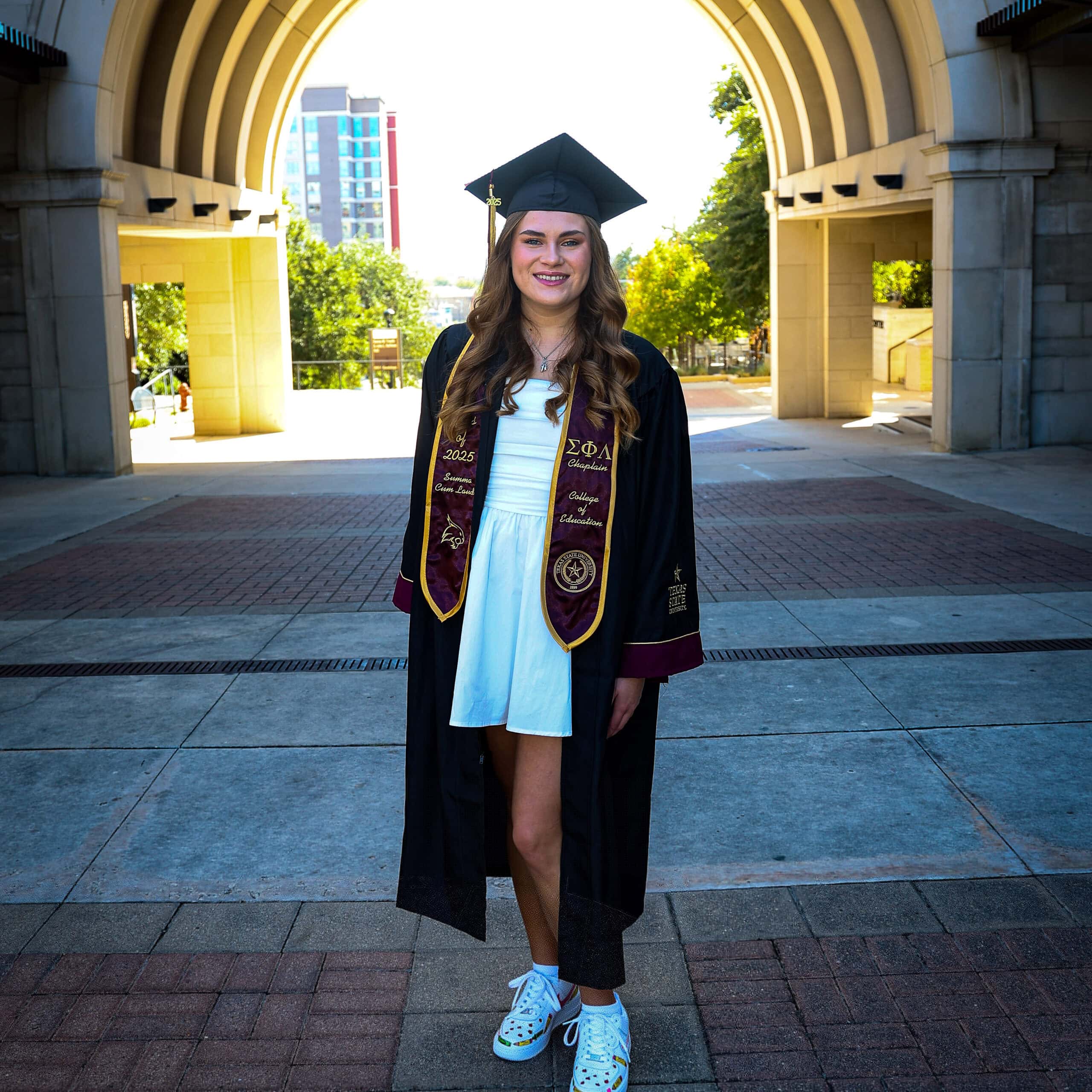 Young woman dressed in cap and gown.