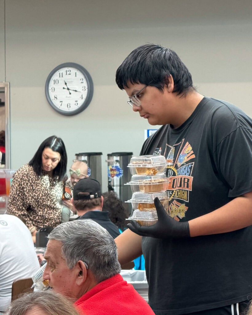 Jones Academy student passes out desserts.
