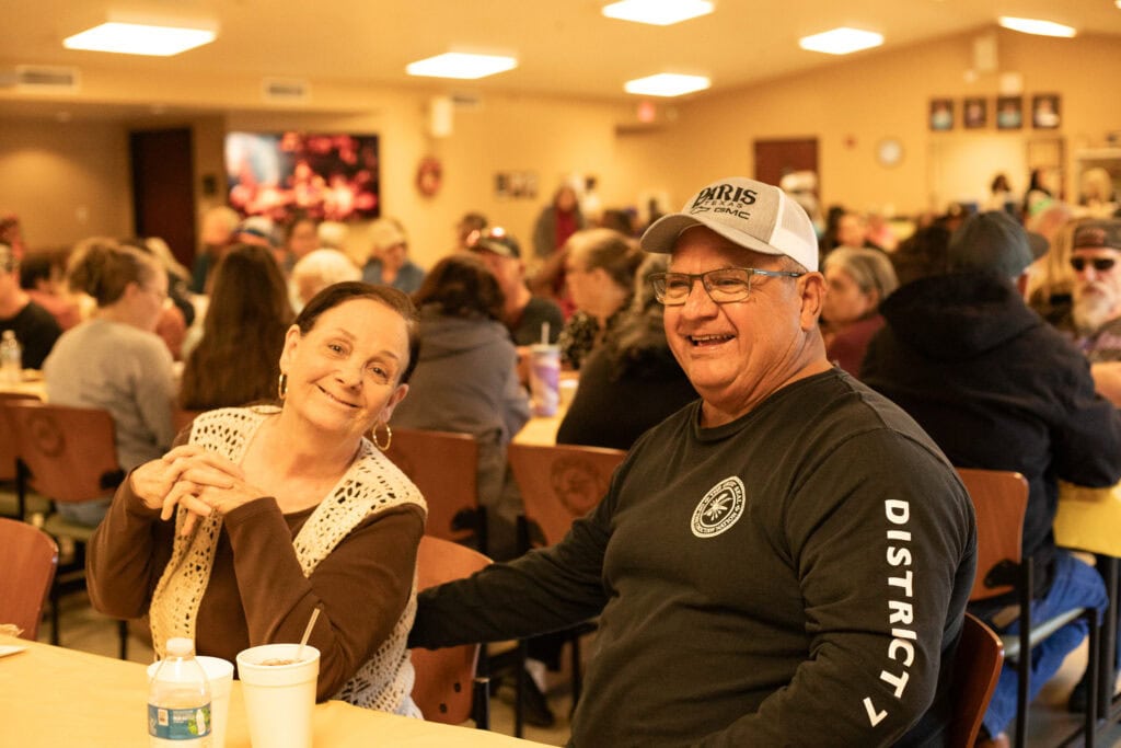 Two elders smile for the camera.