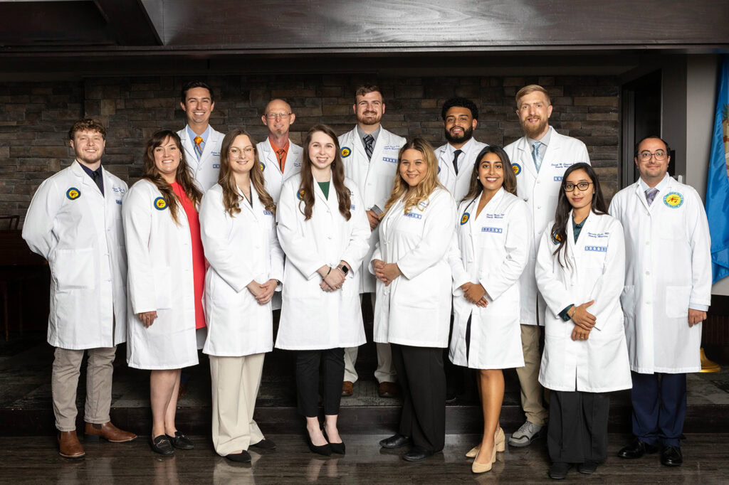 A large group of medical residents pose for a photo.