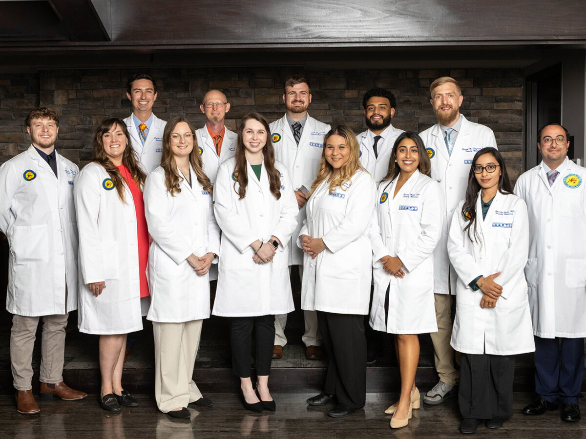 A large group of medical residents pose for a photo.
