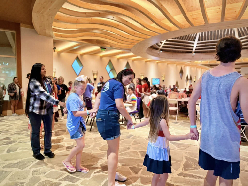 Visitors participate in traditional dancing.