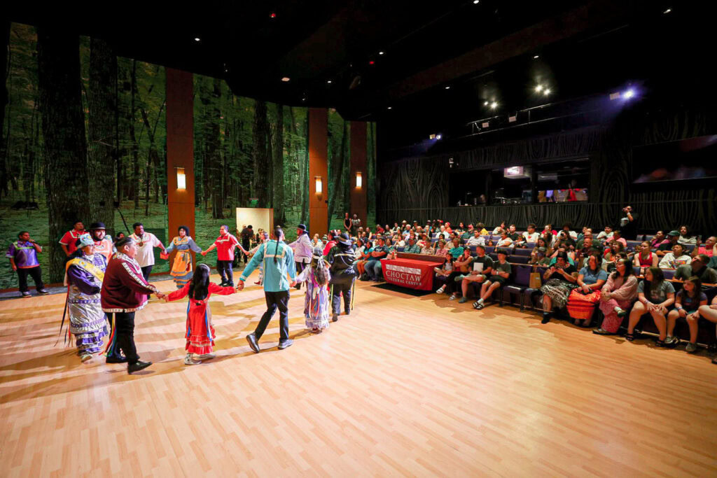 Visitors participate in traditional dancing.