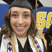 A woman poses for a photo wearing a Choctaw Nation graduation stole.