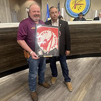 Two men pose for a photo.