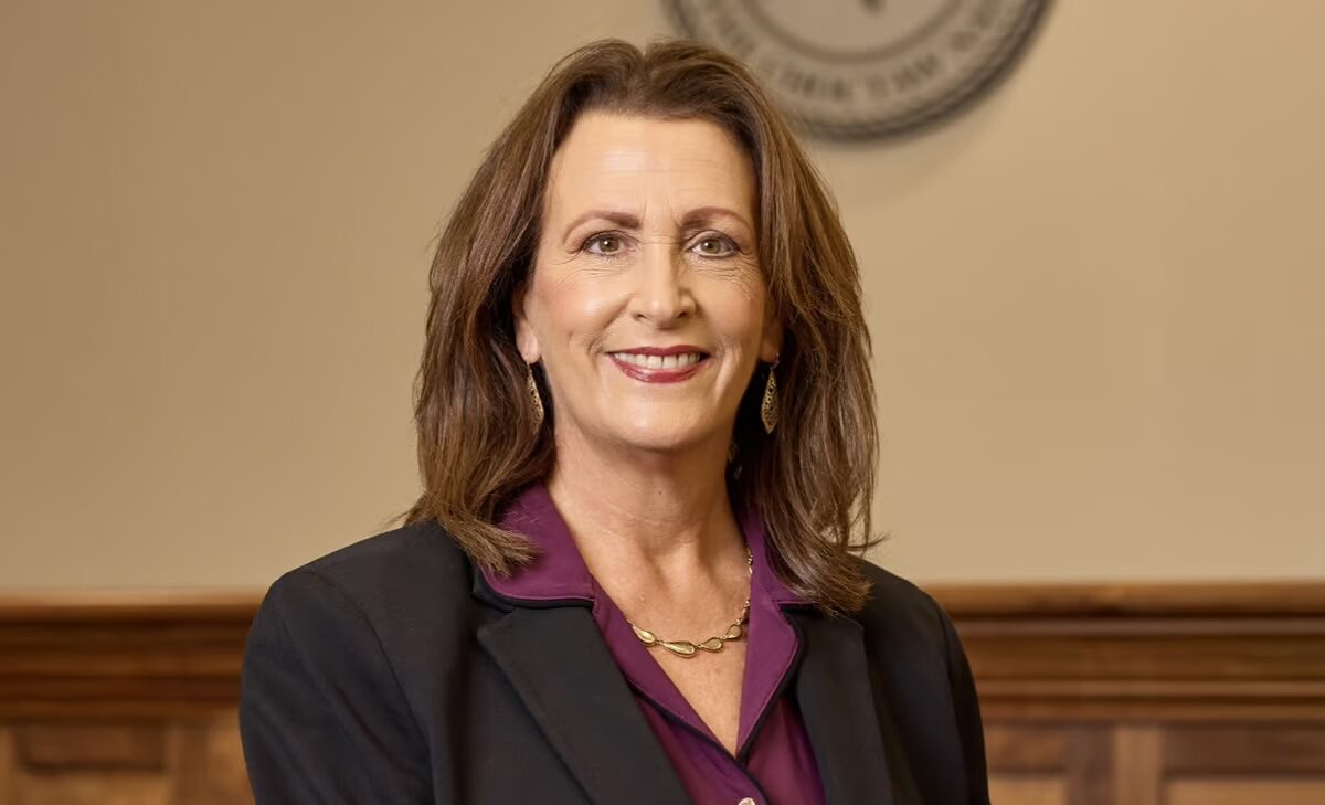 A woman poses for a photo.