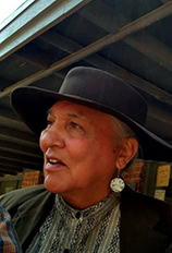 A Native American man looks off to the left.