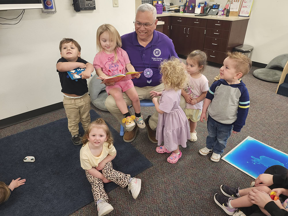 A man reads to a group of children