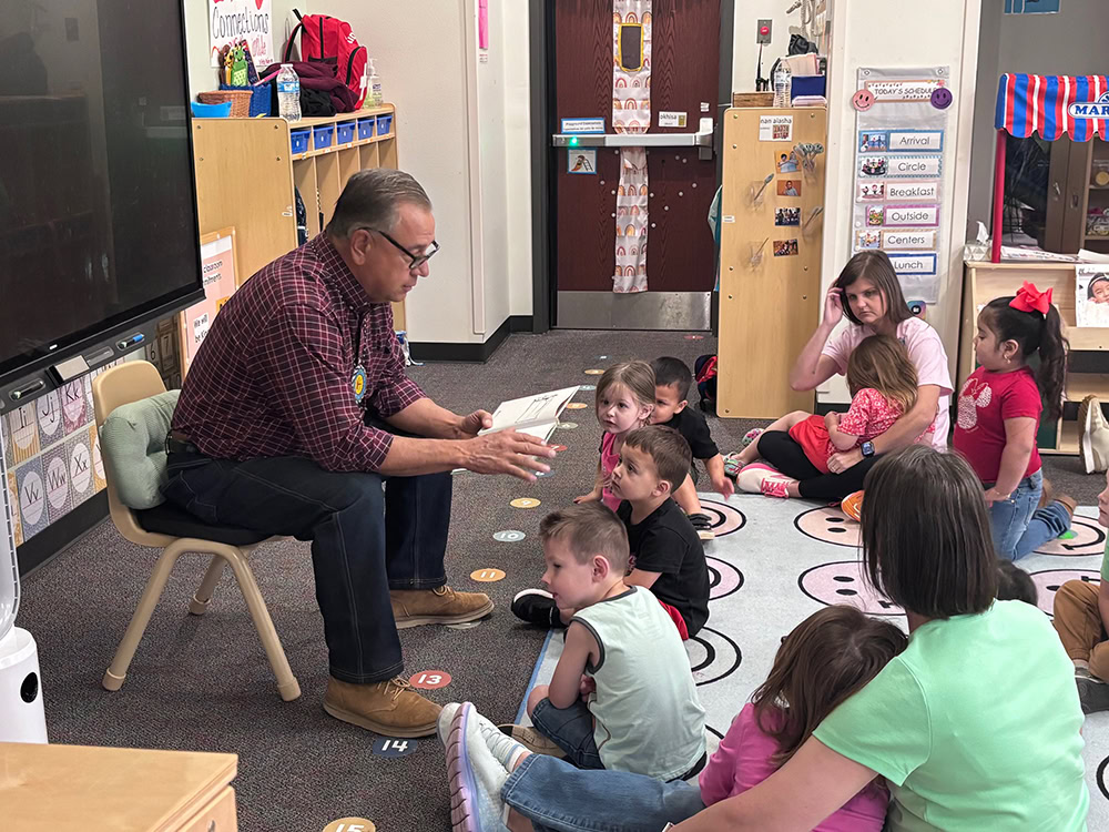 A man reads to children.