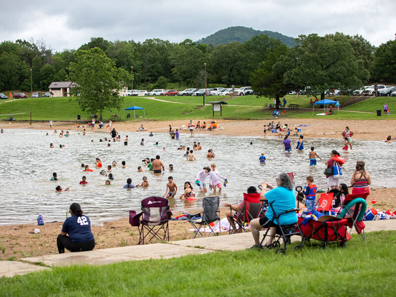 parents watch as kids swim in the lke.