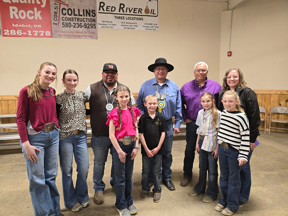 A group of men, women and children pose for a photo. 