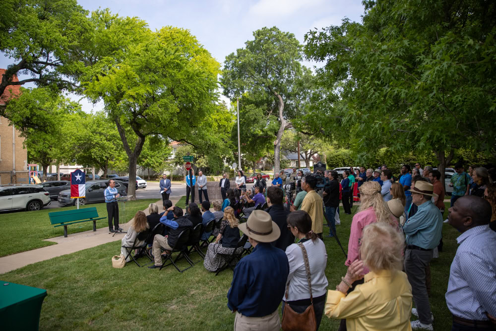 A large group of people gathered in a park.