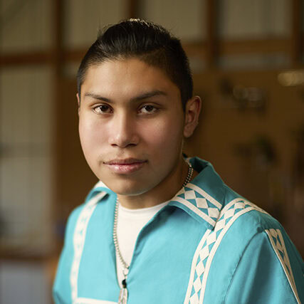 A young man poses for a photo.