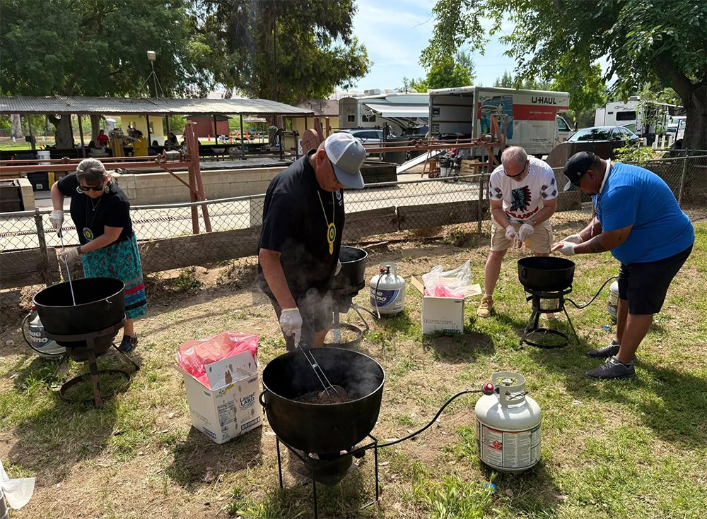 A group of people cook traditional food.